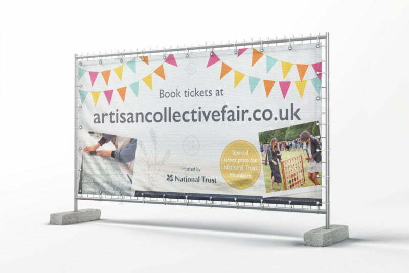 Mesh fence banner displaying event information with bright coloured flags.